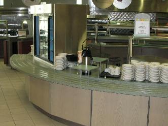 Round Plastic Laminate Wall, Wood Stand-Off Panels, and Solid Surface Countertops with Tray Slide